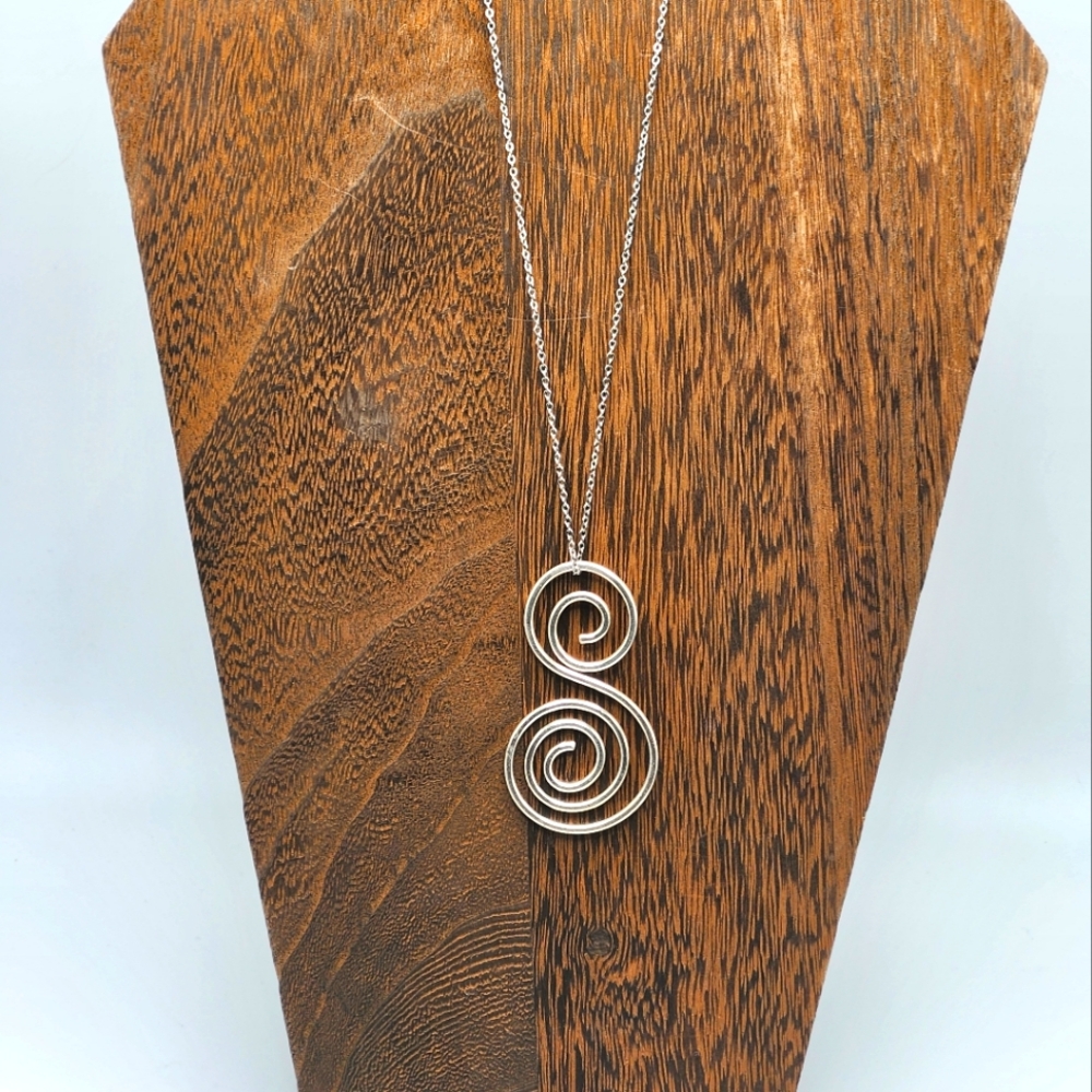 Sterling silver:S" loopy looping design pendant and Sterling chain.  Mod letter